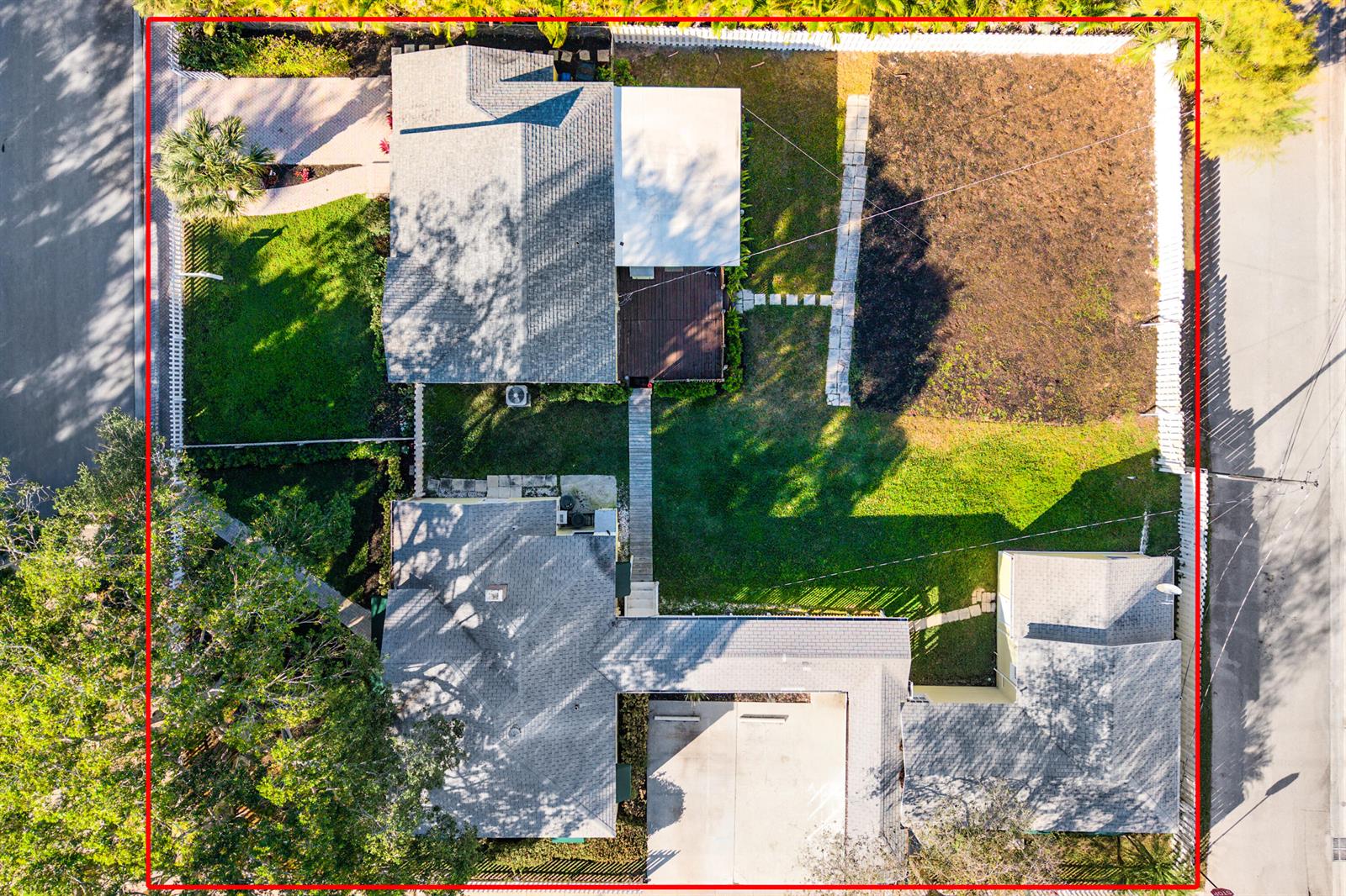 Aerial view of a residential property featuring two houses, a large yard, and surrounding fences — 201 NE 1st Avenue, Delray Beach FL 33444, DELRAY BEACH, FL
