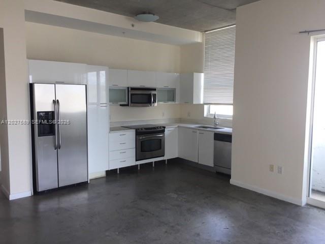 A modern building lobby features high ceilings, pendant lighting, polished concrete floors, and elevator access — 133 NE 2nd Ave # 913, Miami FL 33132, MIAMI, FL