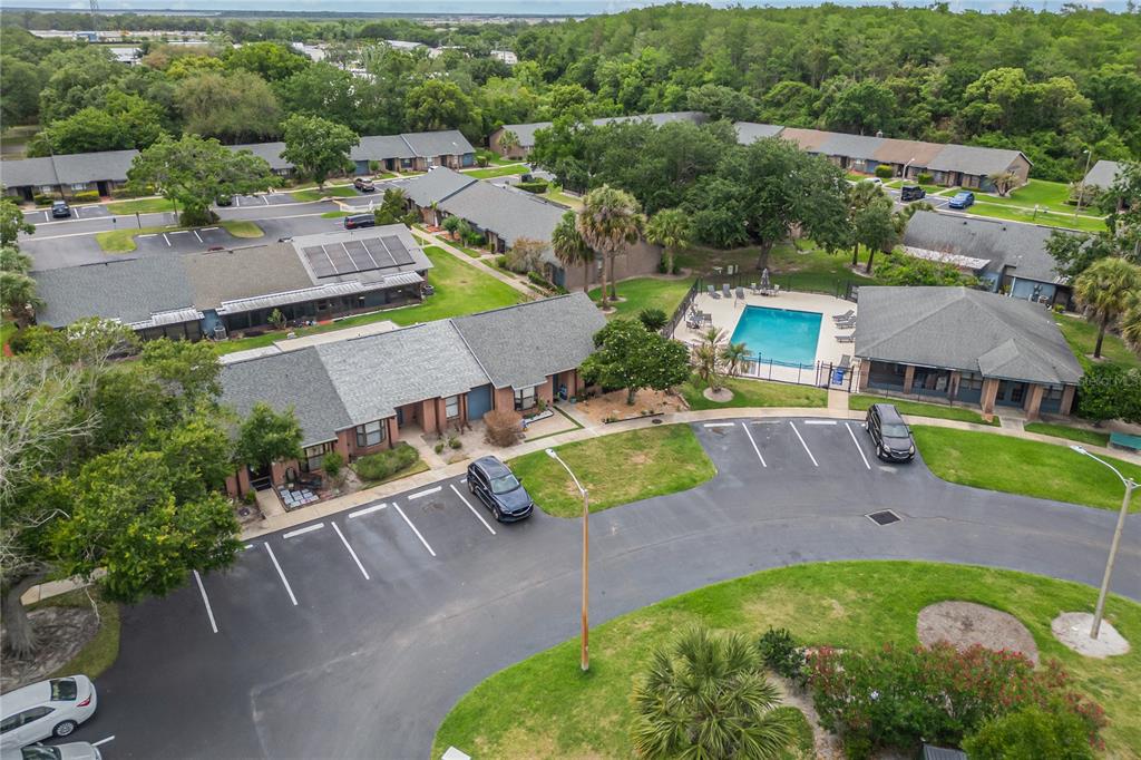 An aerial view shows a residential complex with a swimming pool and parking lot — 2818 SHANNON OAK COURT, ST CLOUD, FL