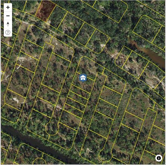 This is an aerial map view showing a vacant residential lot outlined in yellow — 1228 HARBOUR HIBISCUS COURT, PUNTA GORDA, FL