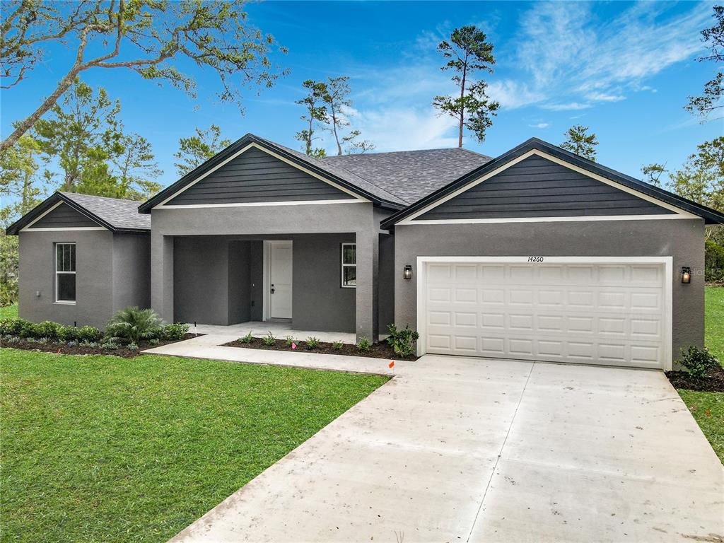 A gray single-story house with a two-car garage and a covered front entryway — 41260 BALSAM STREET, EUSTIS, FL