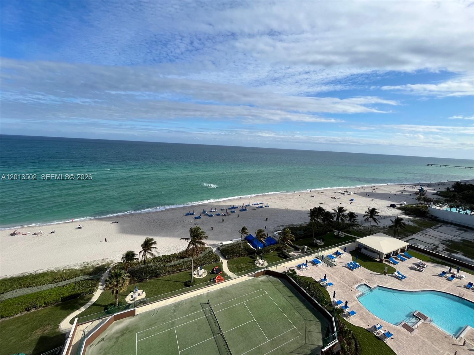 An elevated view of a beach, a tennis court, and a swimming pool — SUNNY ISLES BEACH, FL