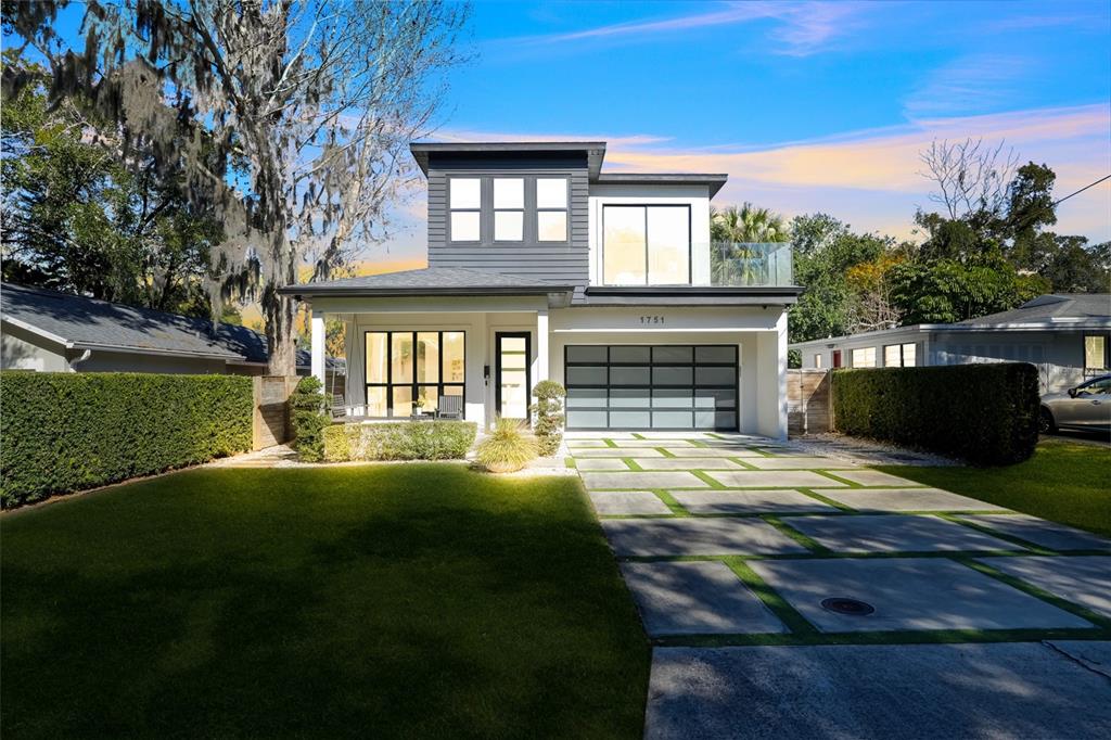 A modern two-story house features a gray upper level, white lower level, and paved driveway — 1751 GOODRICH AVENUE, WINTER PARK, FL