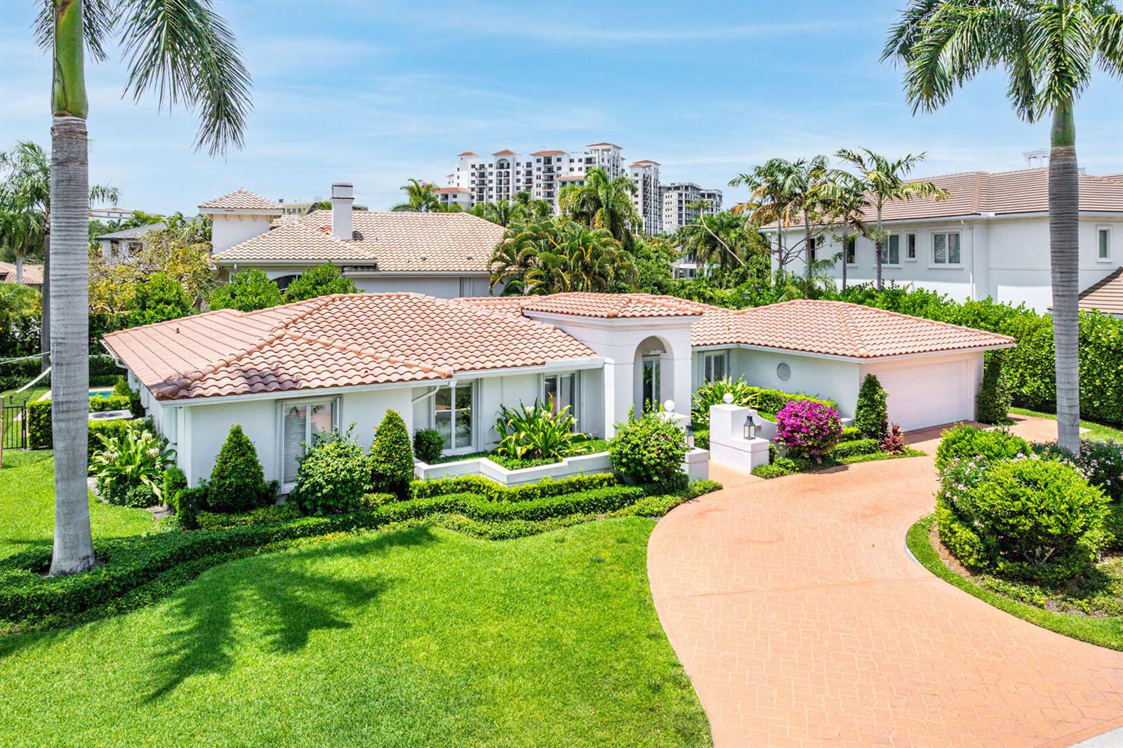 A single-story white house with a terracotta tile roof and a curved brick driveway — 1251 Thatch Palm Drive, Boca Raton FL 33432, BOCA RATON, FL