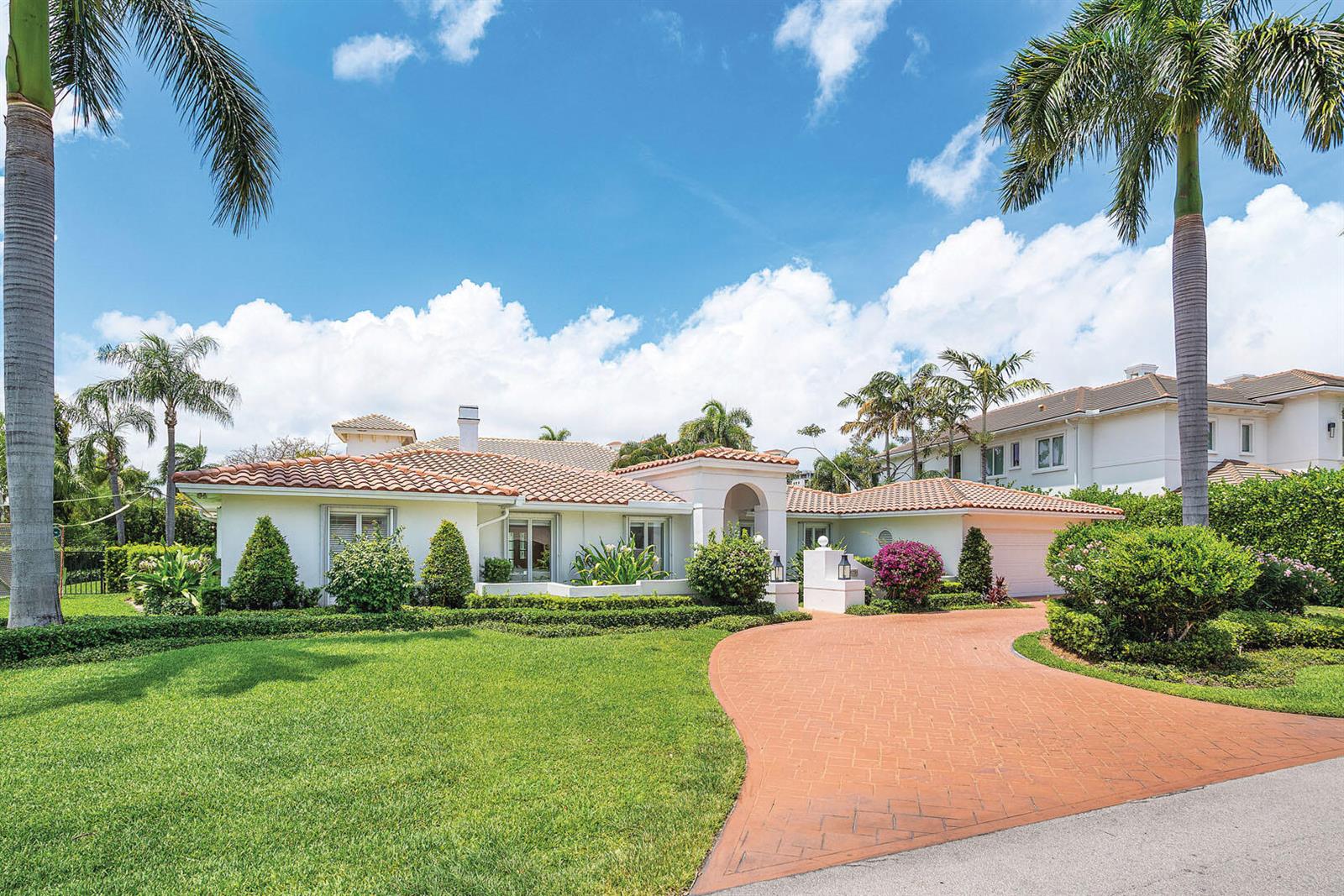 A single-story white house with a terracotta tile roof and a curved brick driveway — 1251 Thatch Palm Drive, Boca Raton FL 33432, BOCA RATON, FL