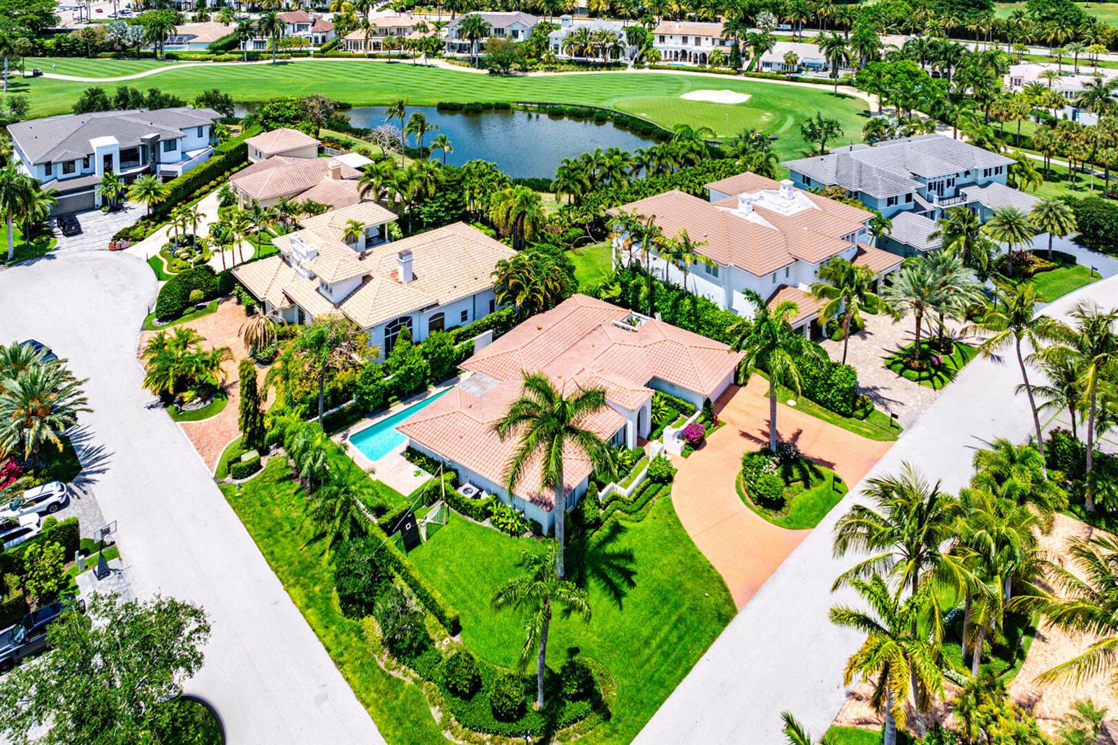An aerial view shows several large houses with tile roofs, swimming pools, and palm trees — 1251 Thatch Palm Drive, Boca Raton FL 33432, BOCA RATON, FL