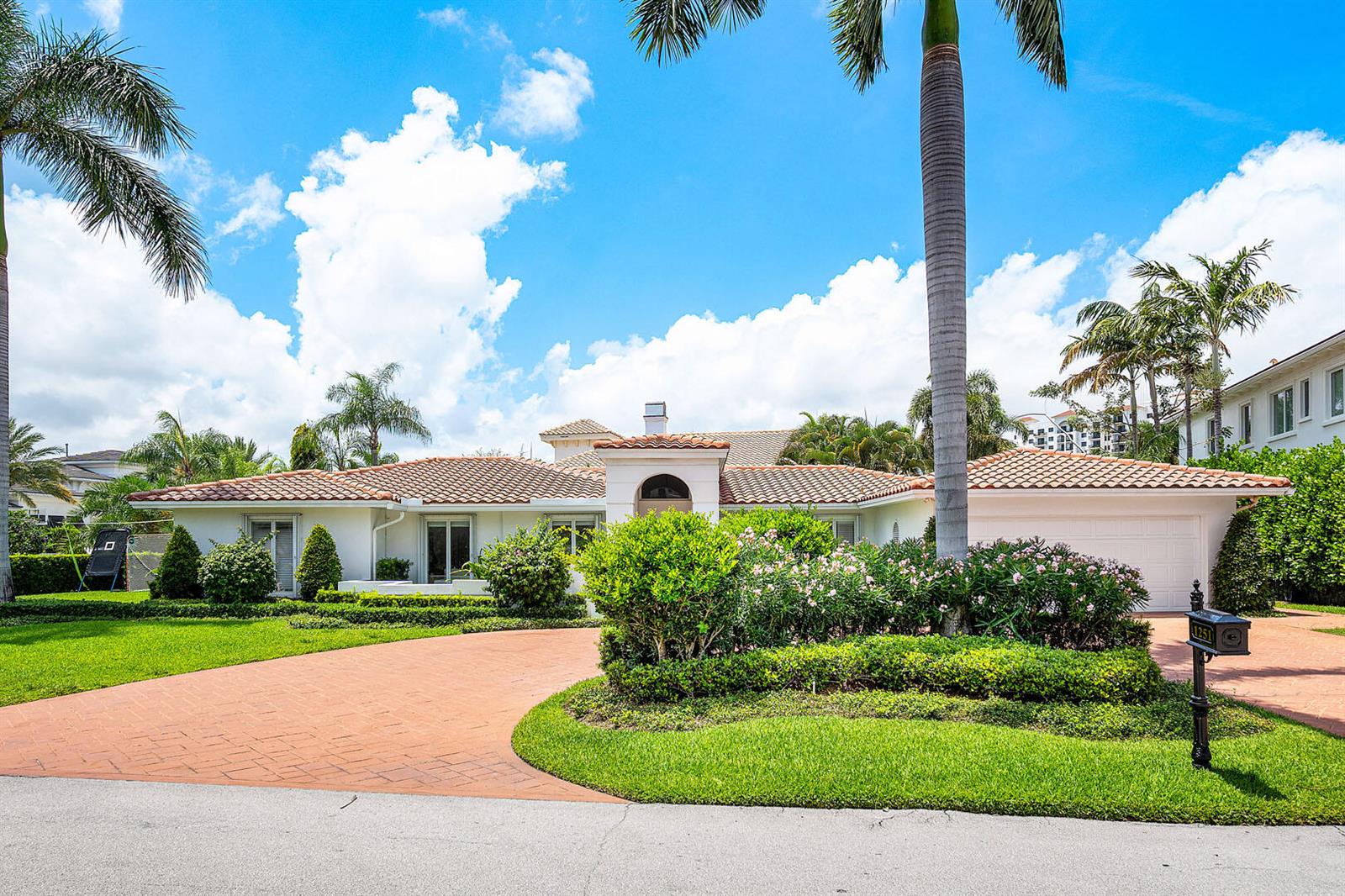 A single-story white house with a tile roof, circular driveway, and palm trees — 1251 Thatch Palm Drive, Boca Raton FL 33432, BOCA RATON, FL