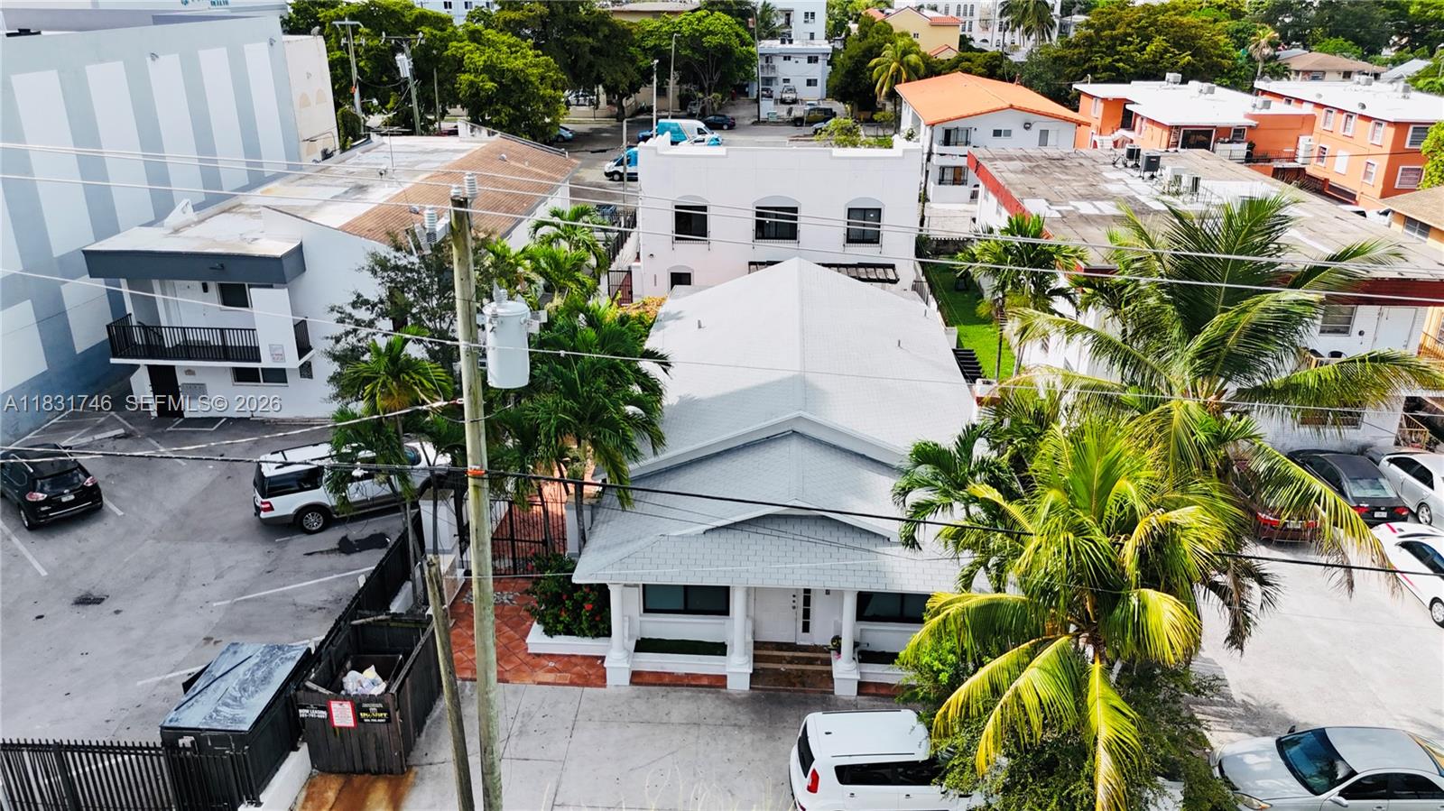 An aerial view shows a white building with a gray roof surrounded by palm trees — 1236 SW 4th St, Miami FL 33135, MIAMI, FL