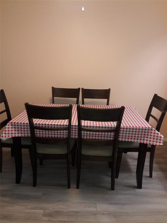 A dining room features a rectangular table with a red and white checkered tablecloth — 2713 60TH AVENUE DRIVE W, BRADENTON, FL