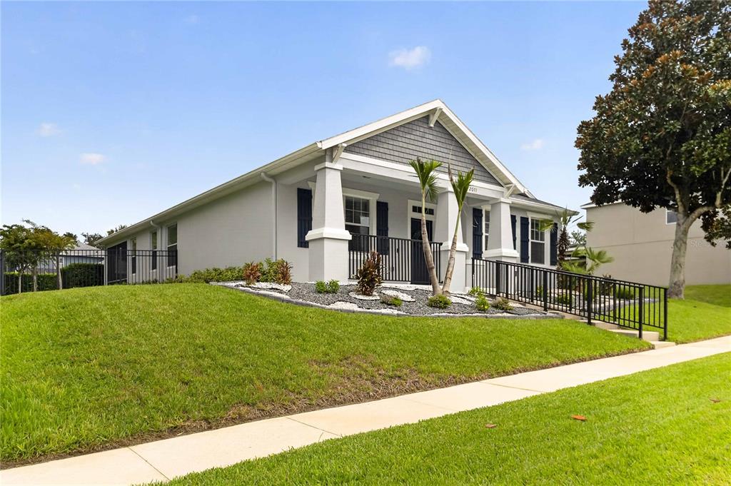 A single-story house with a gray exterior, shingled gable, and a front porch with railing — 2071 RAFTON ROAD, APOPKA, FL