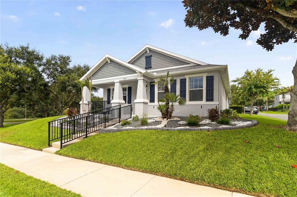 A single-story house with a gray exterior, a front porch, and a black metal ramp — 2071 RAFTON ROAD, APOPKA, FL