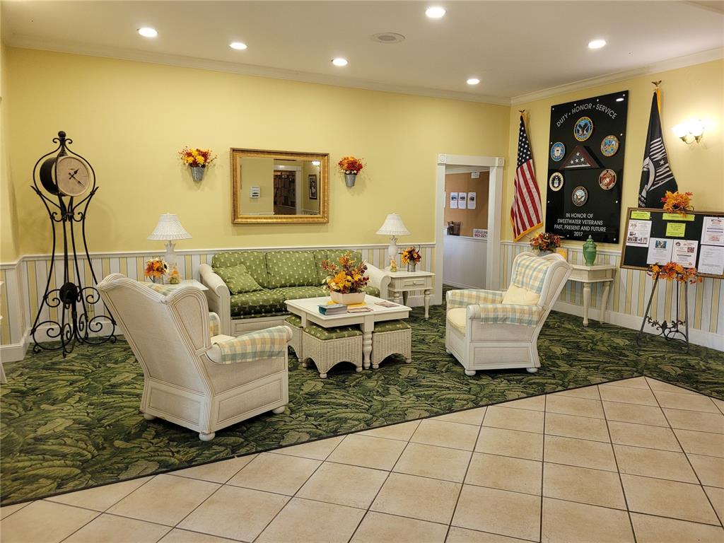 A waiting room features a green patterned sofa, two armchairs, and a veteran memorial display — 213 YORK COTTAGE DRIVE, HAINES CITY, FL