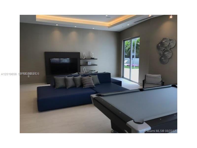 A living room features a blue sectional sofa, a pool table, and a wall-mounted television — 1010 SW 2nd Ave # 1105, Miami FL 33130, MIAMI, FL