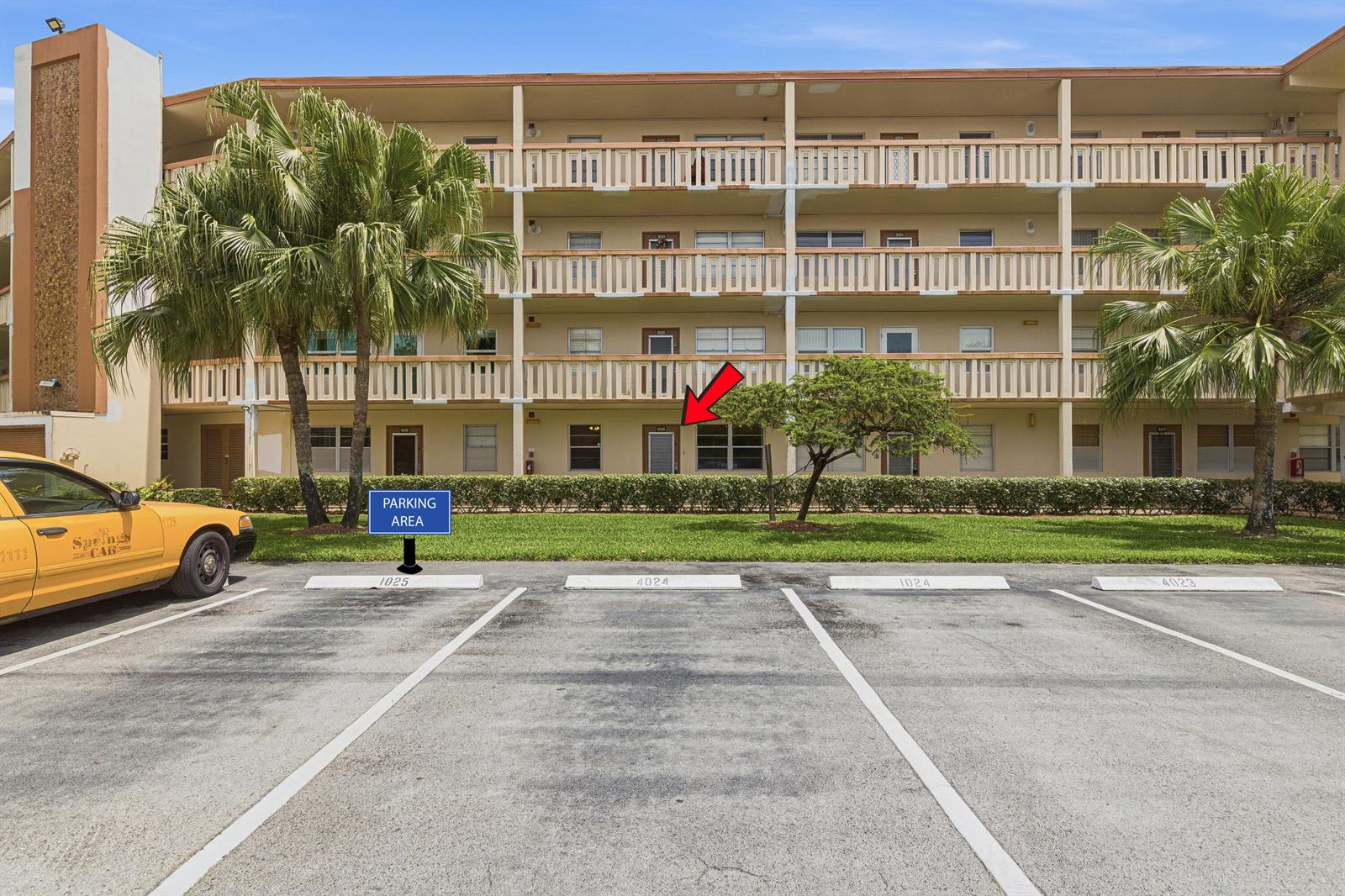 A multi-story apartment building exterior features a ground-level unit marked by a red arrow — 1025 Newcastle B # 1025, Boca Raton FL 33434, BOCA RATON, FL