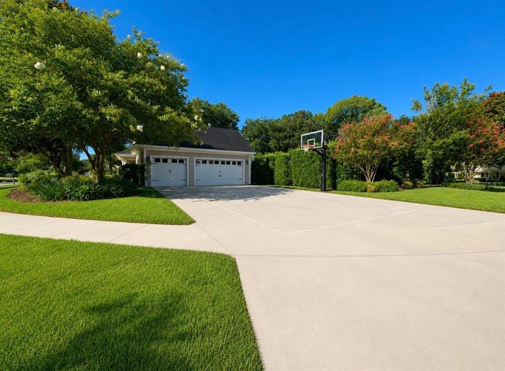 A detached two-car garage with a basketball hoop on a concrete driveway — 5650 KILLIANS PATH, WESLEY CHAPEL, FL