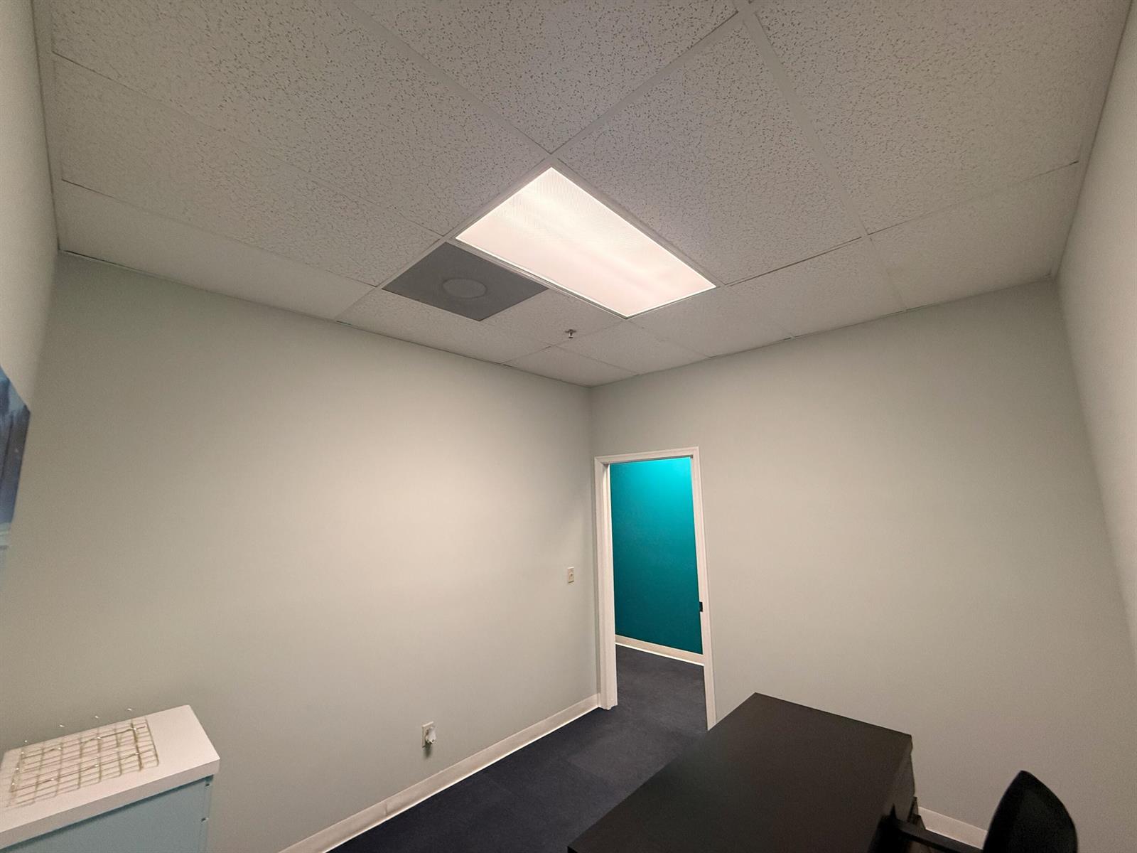 A small office features light gray walls, a drop ceiling with a light, and carpet — 6103 SE Federal Highway, Stuart FL 34997, STUART, FL