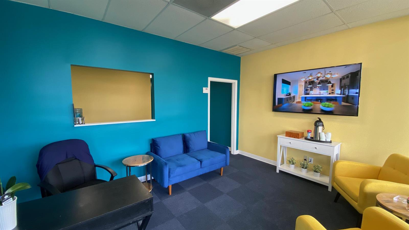 A waiting room features a blue accent wall, a yellow accent wall, and colorful furniture — 6103 SE Federal Highway, Stuart FL 34997, STUART, FL