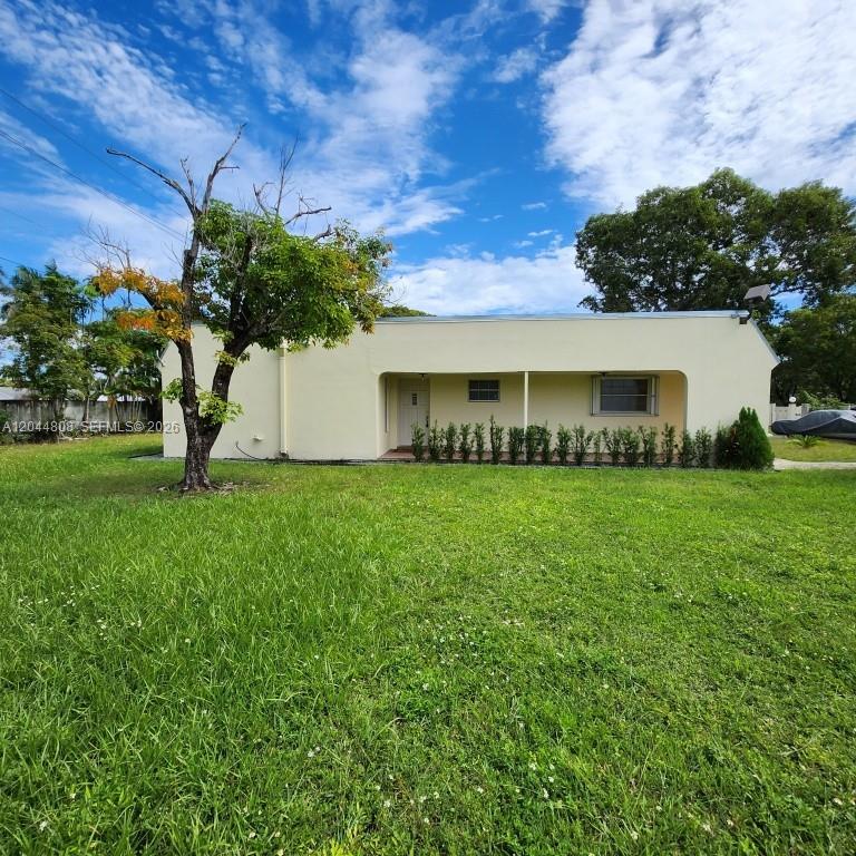 A single-story, light-colored house with a covered front porch sits behind a large lawn — 11249 SW 169th St # V4831, Miami FL 33157, MIAMI, FL