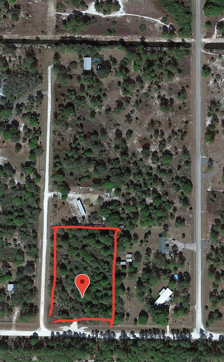 An aerial view of a rectangular, wooded plot of land outlined in red — 681 N Perimeter Road, Clewiston FL 33440, CLEWISTON, FL