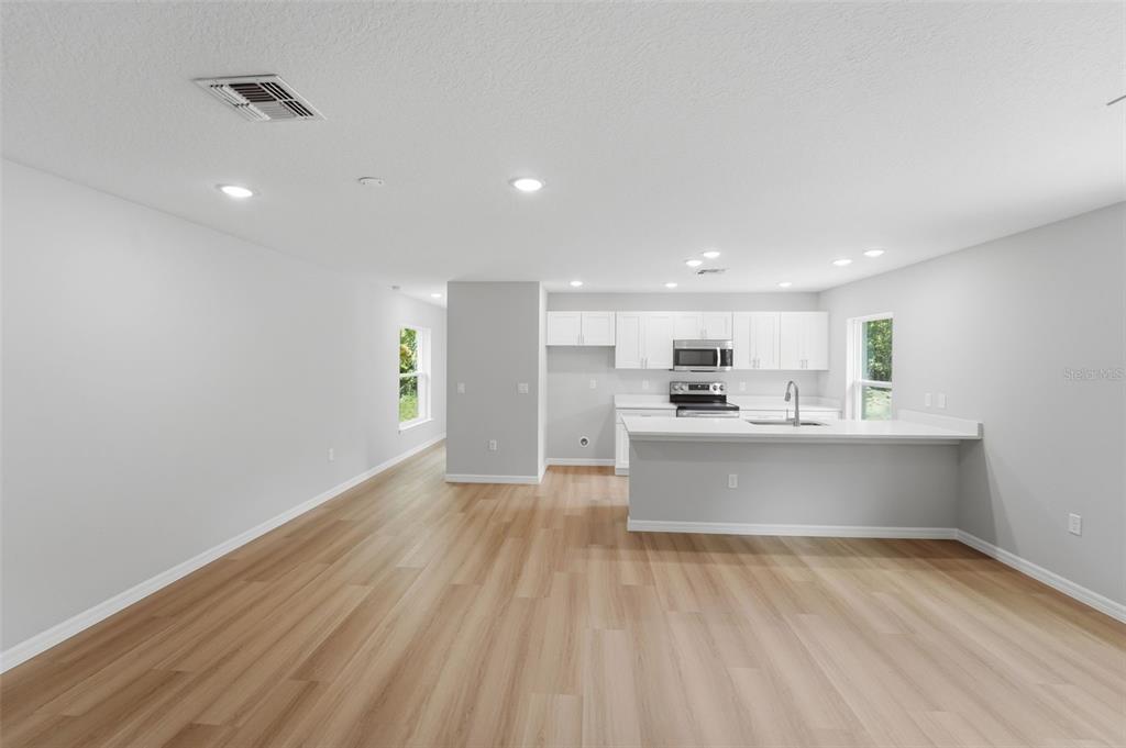 A detached white garage with a blue door and matching blue garage door — 522 PALMETTO STREET, EUSTIS, FL