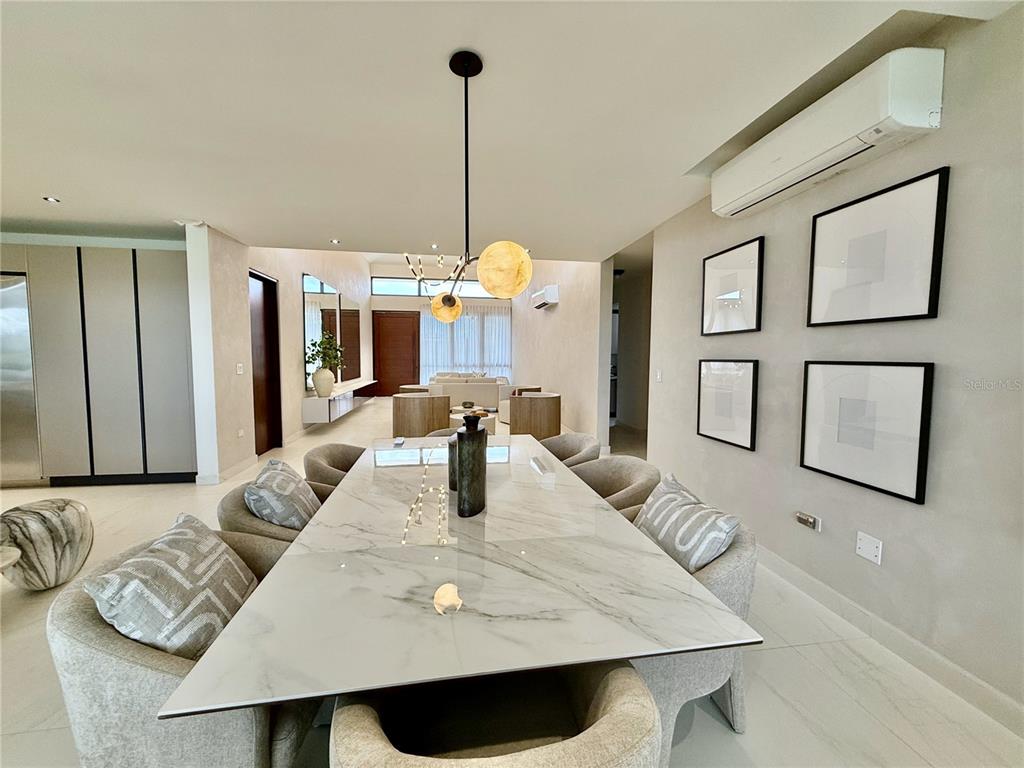 A dining room features a marble-topped table, upholstered chairs, and a modern light fixture — 9 LOS LAGOS, HUMACAO, PR