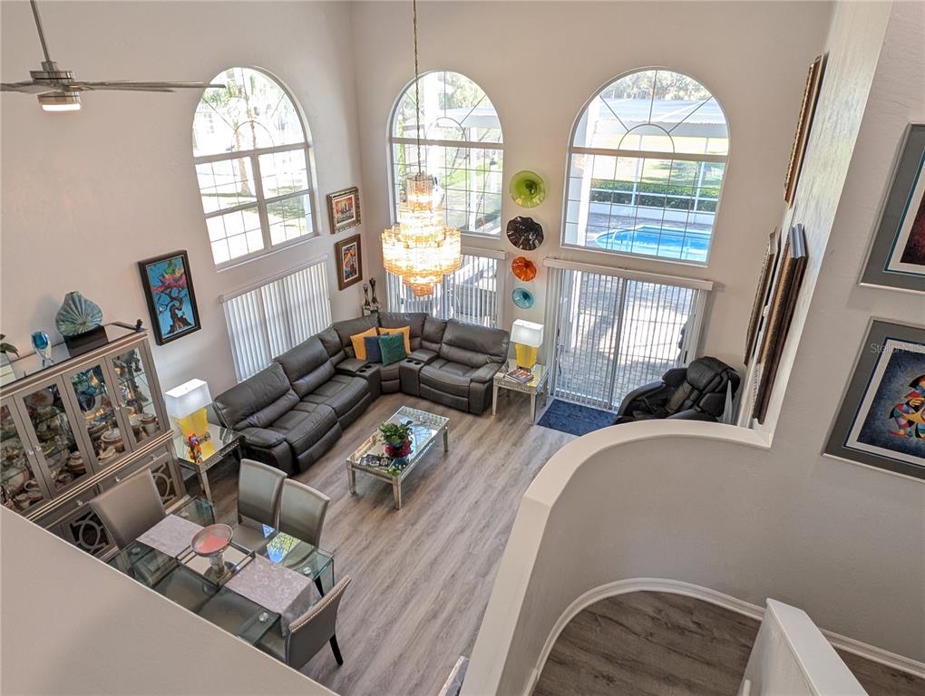 A two-story gray house features a paved driveway, a screened garage, and palm trees — 9 MOUNT VERNON LANE, PALM COAST, FL