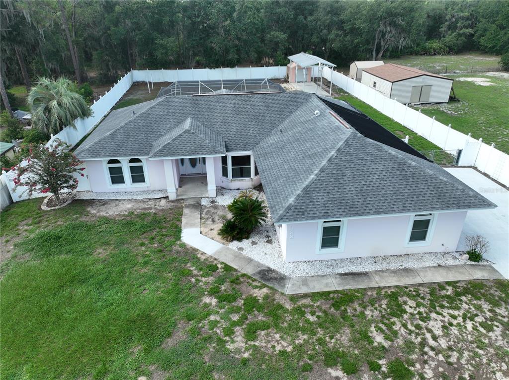 An aerial view of a single-story house with a gray roof and light-colored exterior — 122 QUAILWOOD DRIVE, WINTER HAVEN, FL