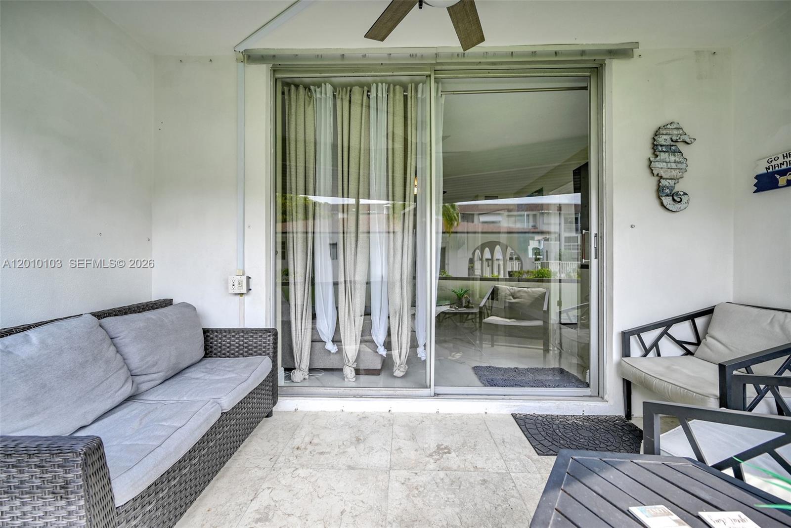 An aerial view shows a rectangular swimming pool surrounded by a patio and palm trees — 400 SE 10th St # 105, Deerfield Beach FL 33441, DEERFIELD BEACH, FL