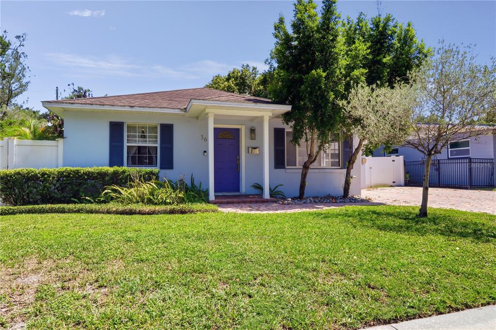 A single-story house with a purple front door, white siding, and a green lawn — 36 E WINTER PARK STREETS, ORLANDO, FL