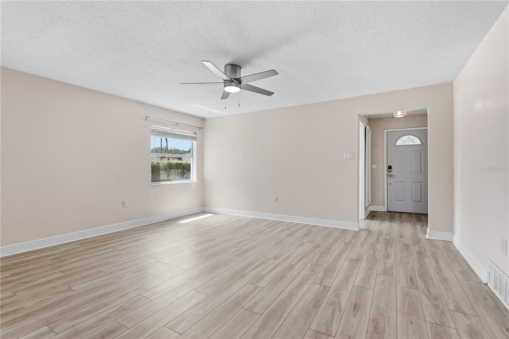 A bright purple front door with a glass archway is centered on a light blue wall — 36 E WINTER PARK STREETS, ORLANDO, FL