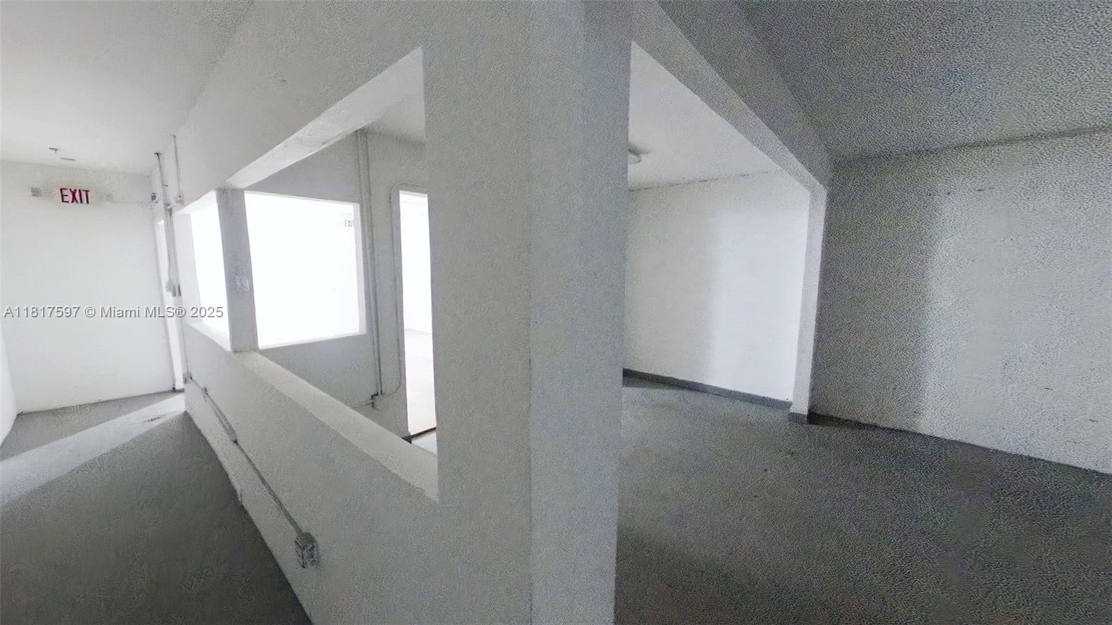 An interior view shows a white-walled room with a large rectangular opening and concrete flooring — 1083 E 24th St, Hialeah FL 33013, HIALEAH, FL