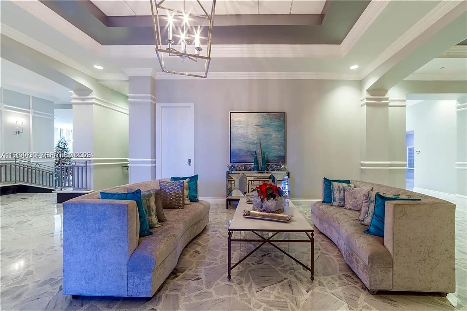 A formal living area features two velvet sofas, a coffee table, and marble flooring — 2501 S Ocean Dr # 429, Hollywood FL 33019, HOLLYWOOD, FL