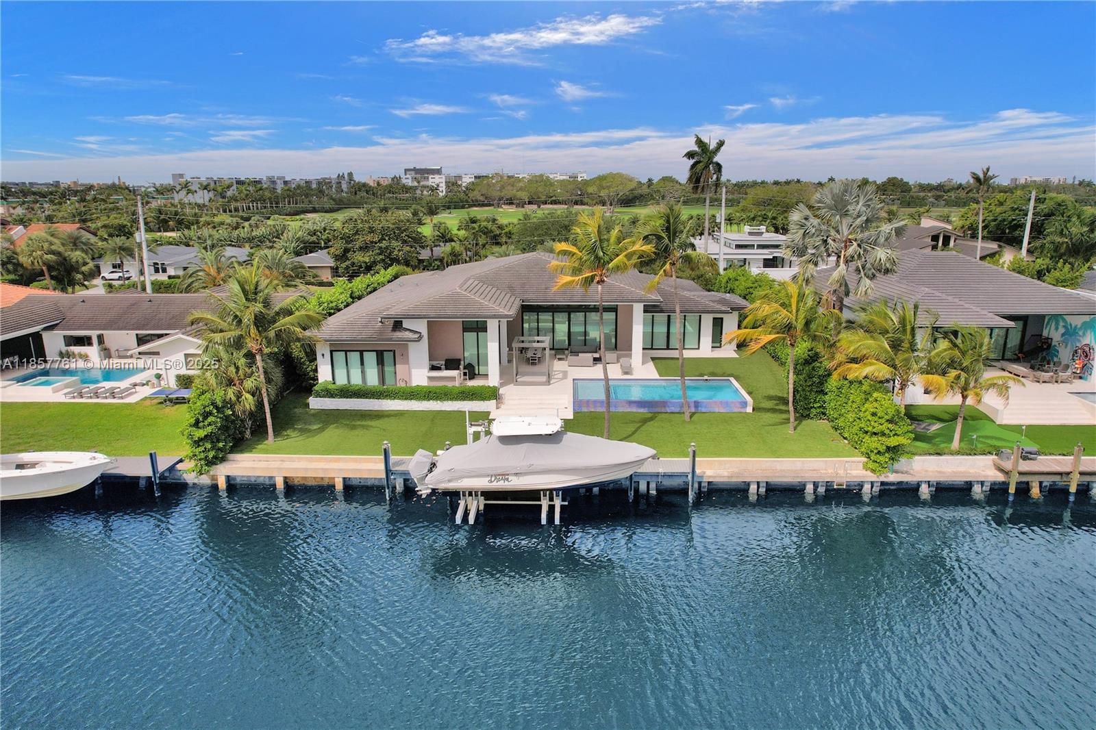 An aerial view of a waterfront house with a swimming pool and a docked boat — 1651 Diplomat Pkwy, Hallandale Beach FL 33009, HALLANDALE BEACH, FL