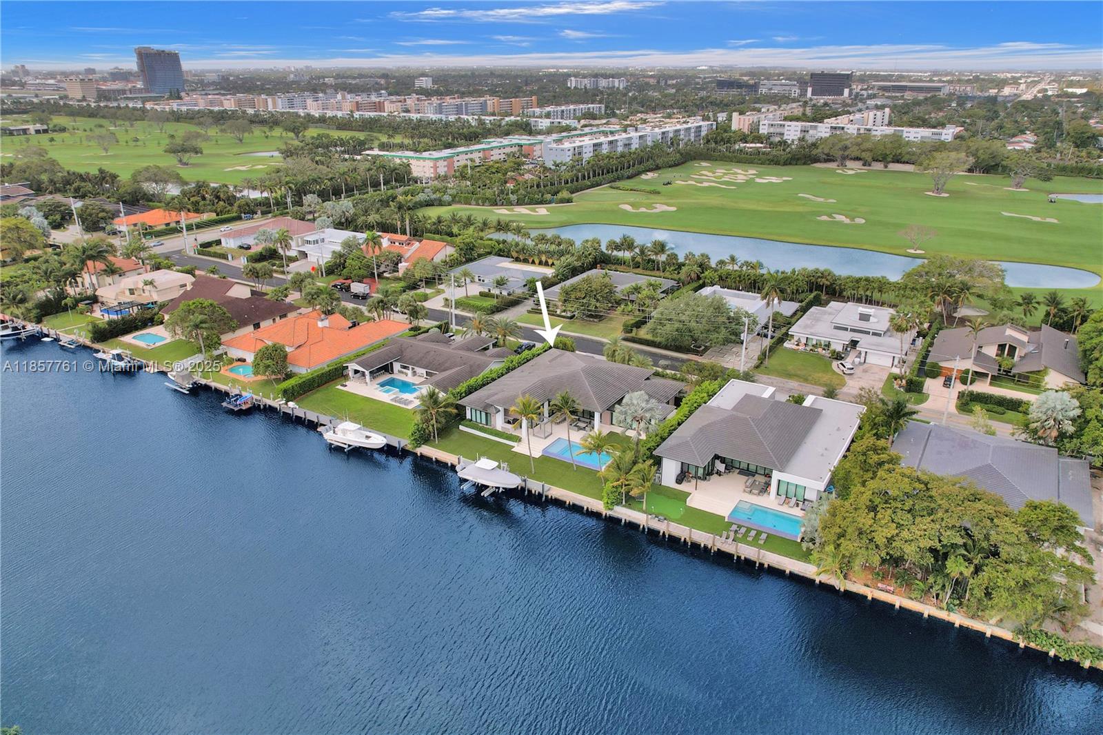 An aerial view shows a waterfront house with a swimming pool and a boat dock — 1651 Diplomat Pkwy, Hallandale Beach FL 33009, HALLANDALE BEACH, FL