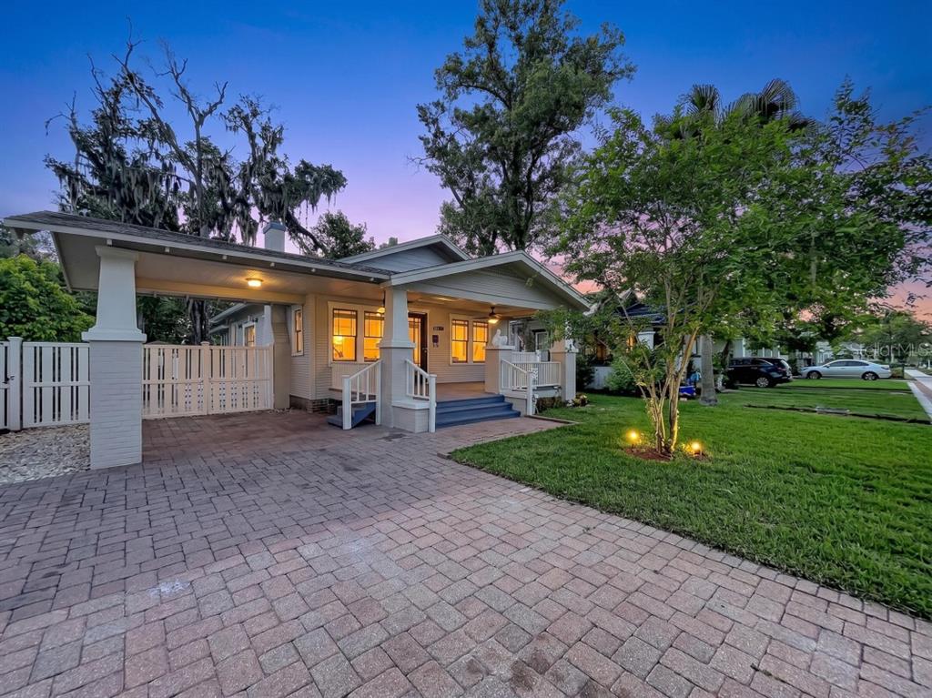 A single-story house with a brick paver driveway, a carport, and a front porch — 806 JOHNSON AVENUE, LAKELAND, FL