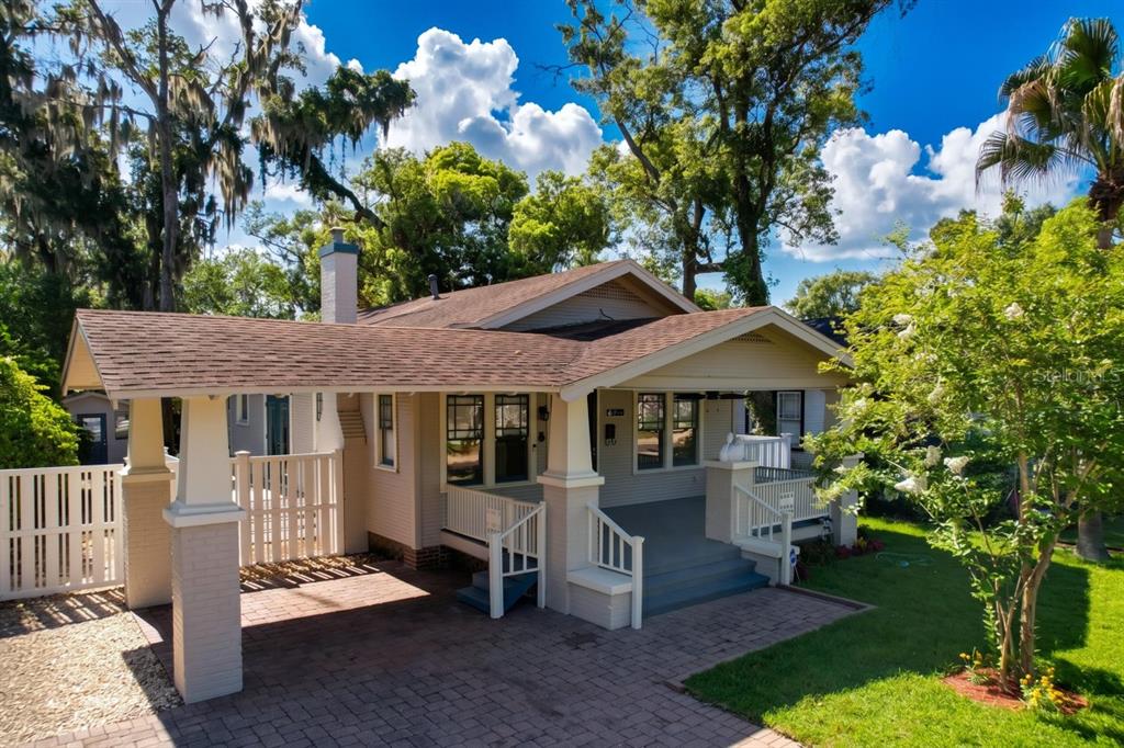 A single-story house with a brick driveway, a covered carport, and a front porch — 806 JOHNSON AVENUE, LAKELAND, FL