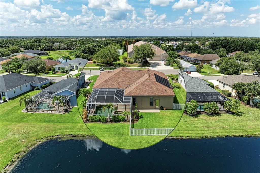 An aerial view shows a suburban house with a screened pool enclosure and backyard pond — 12626 30TH STREET CIRCLE E, PARRISH, FL