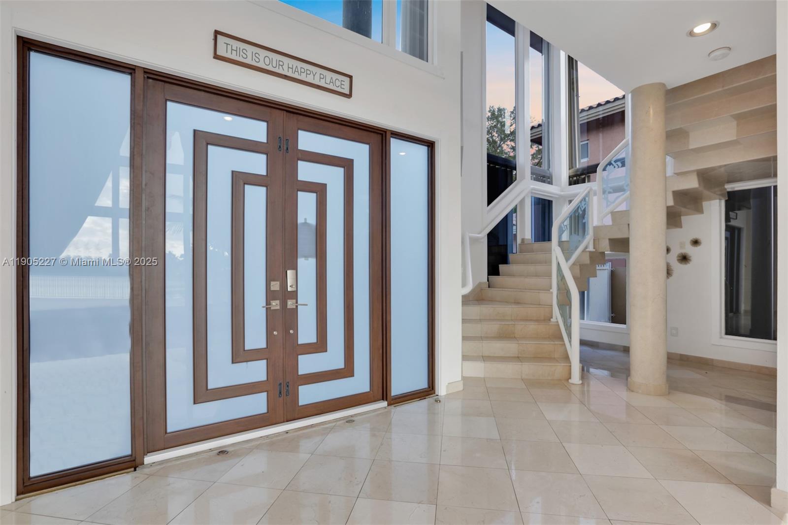 A bright foyer features a double front door, a floating staircase, and polished tile floors — 16232 NW 79th Ave, Miami Lakes FL 33016, MIAMI LAKES, FL