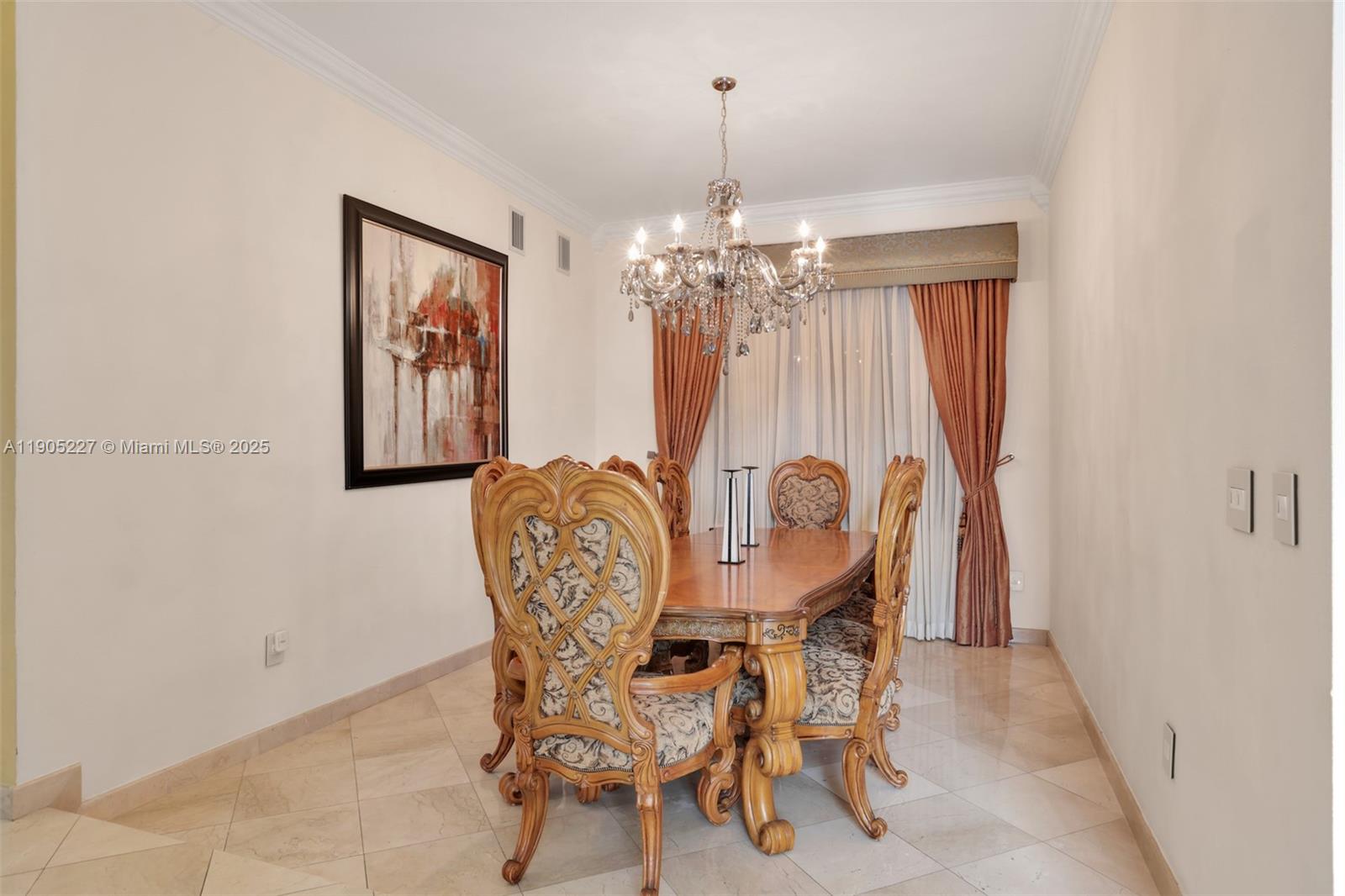 A formal dining room features a wooden table, ornate chairs, a crystal chandelier, and tile flooring — 16232 NW 79th Ave, Miami Lakes FL 33016, MIAMI LAKES, FL