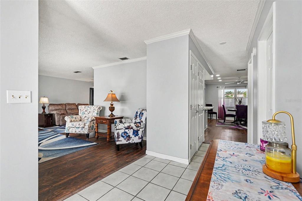 A view from a tiled entryway looking into a living room and dining area — 1501 NEW BEDFORD DRIVE, SUN CITY CENTER, FL