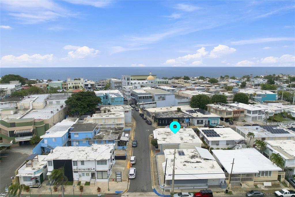 An aerial view shows a city street with a blue location pin over a building — 16 CALLE EDUARDO QUEVEDO, ISABELA, PR