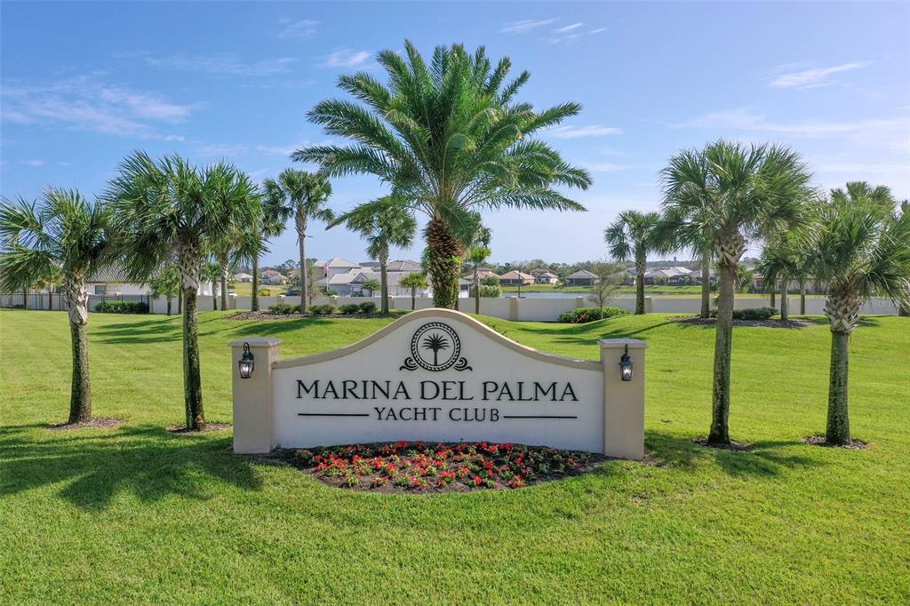 A sign for Marina Del Palma Yacht Club stands in a grassy, palm-lined landscape — 10 RIO VISTA DRIVE, PALM COAST, FL