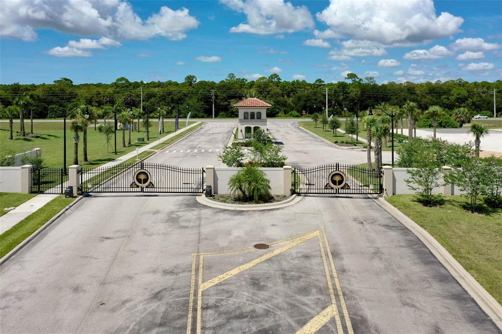 An aerial view of a gated entrance with a guardhouse and paved driveway — 10 RIO VISTA DRIVE, PALM COAST, FL