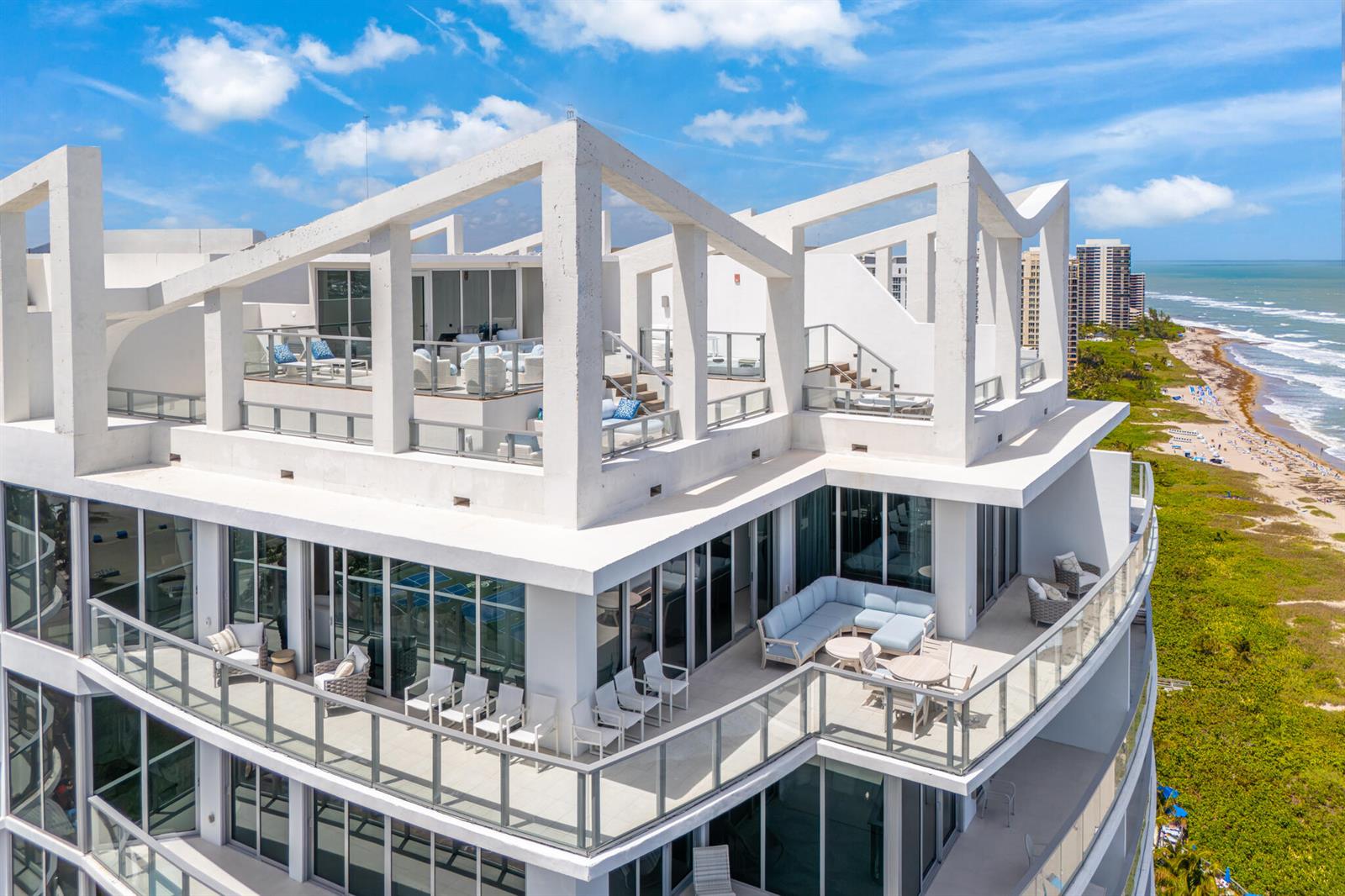 An aerial view of a modern building rooftop terrace featuring outdoor seating and ocean views — 3100 N Ocean Drive, Riviera Beach FL 33404, RIVIERA BEACH, FL