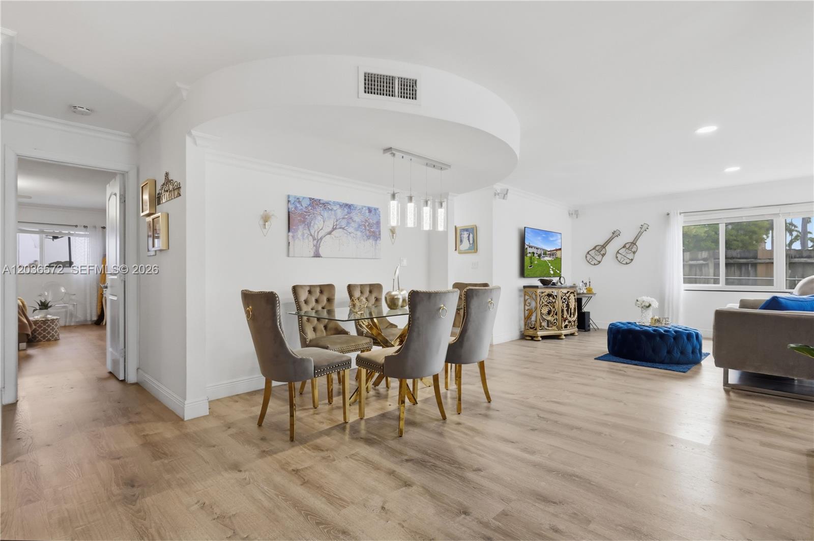 A dining area with a glass table and velvet chairs sits beneath a curved ceiling — 1040 Crystal Lake Dr # 3, Deerfield Beach FL 33064, DEERFIELD BEACH, FL