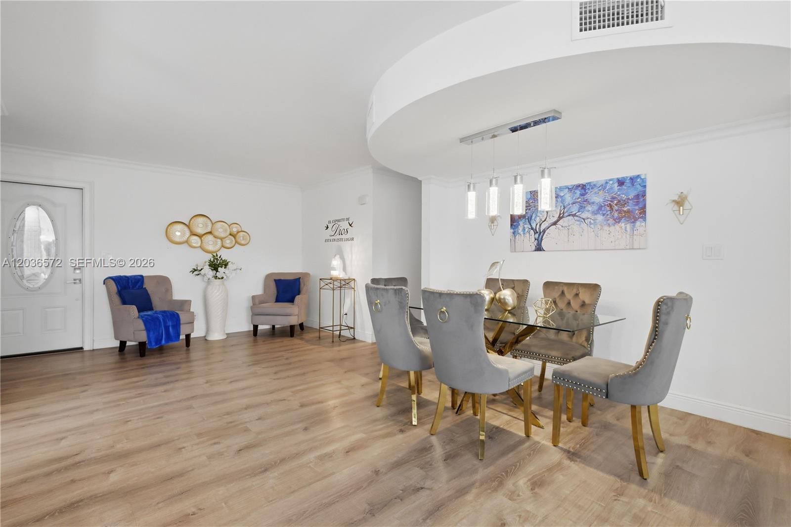 A dining area with a glass table, grey velvet chairs, and a nearby seating space — 1040 Crystal Lake Dr # 3, Deerfield Beach FL 33064, DEERFIELD BEACH, FL