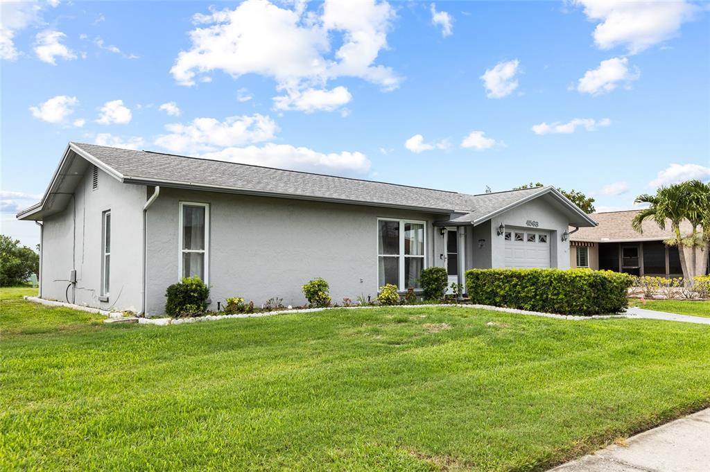 A single-story gray house with a shingled roof and a front-facing garage — 4563 GREAT LAKES DRIVE S, CLEARWATER, FL