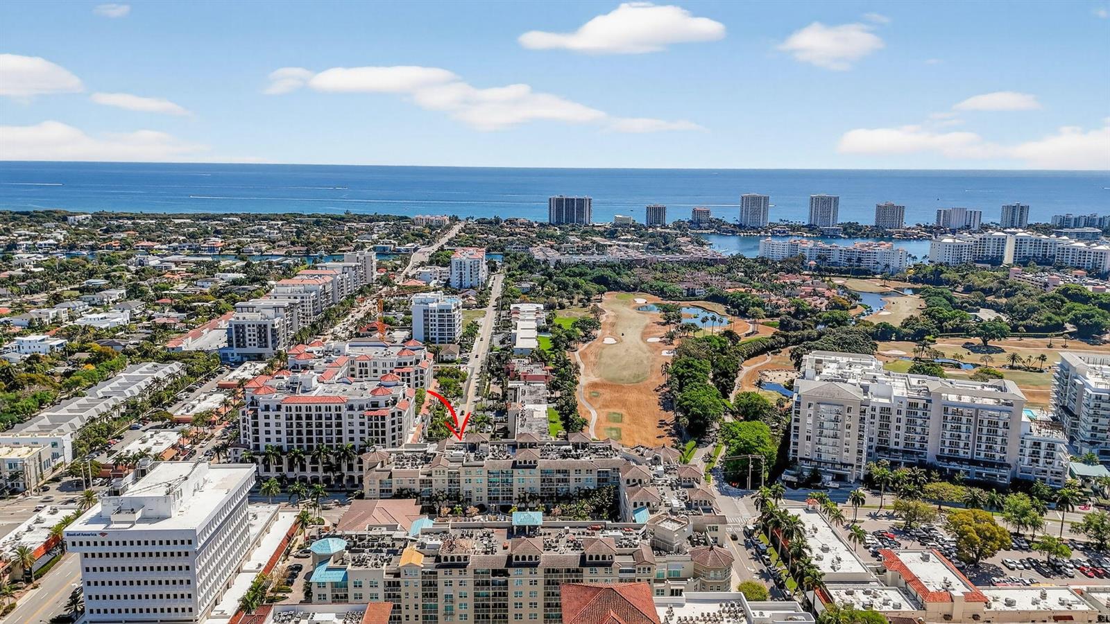 An aerial view shows a coastal city with high-rise buildings, a golf course, and ocean — 99 SE Mizner Boulevard # 603, Boca Raton FL 33432, BOCA RATON, FL