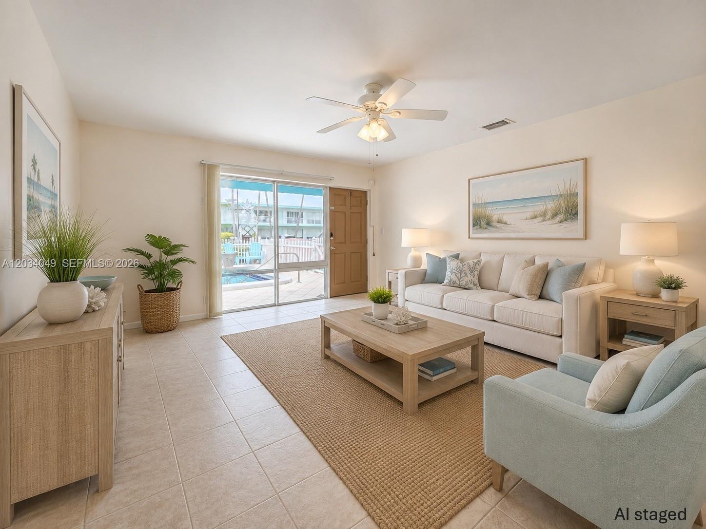 This living room features a beige sofa, light blue armchair, coffee table, and sliding doors — 3217 NE 7th Pl # 4, Pompano Beach FL 33062, POMPANO BEACH, FL