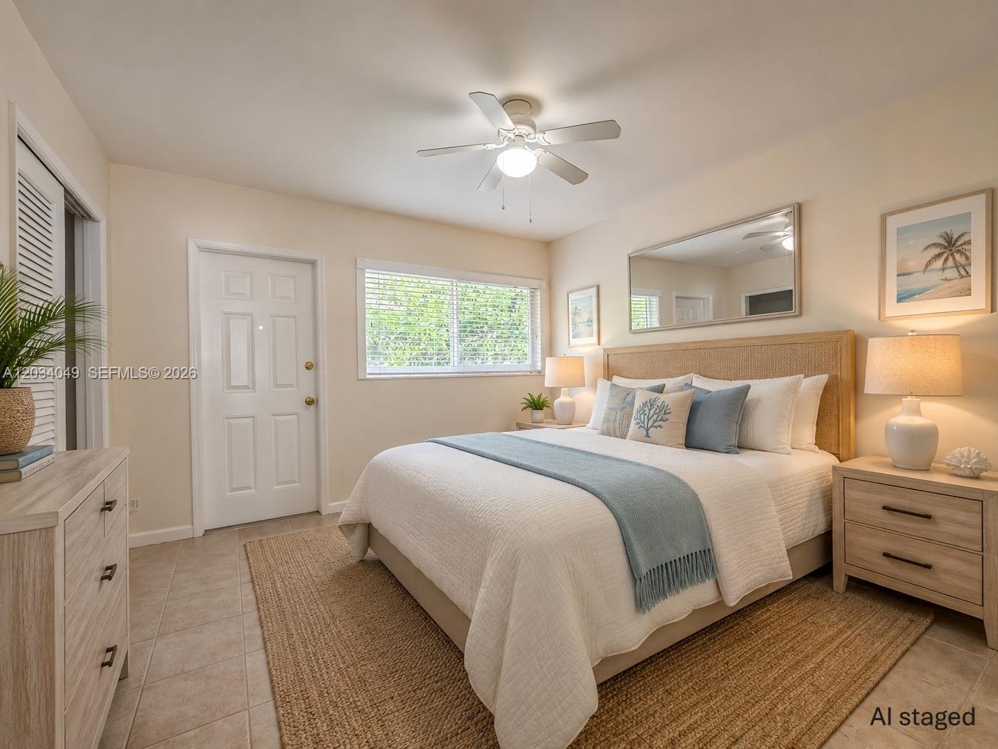 A staged bedroom features a queen bed, light wood furniture, a ceiling fan, and tile flooring — 3217 NE 7th Pl # 4, Pompano Beach FL 33062, POMPANO BEACH, FL